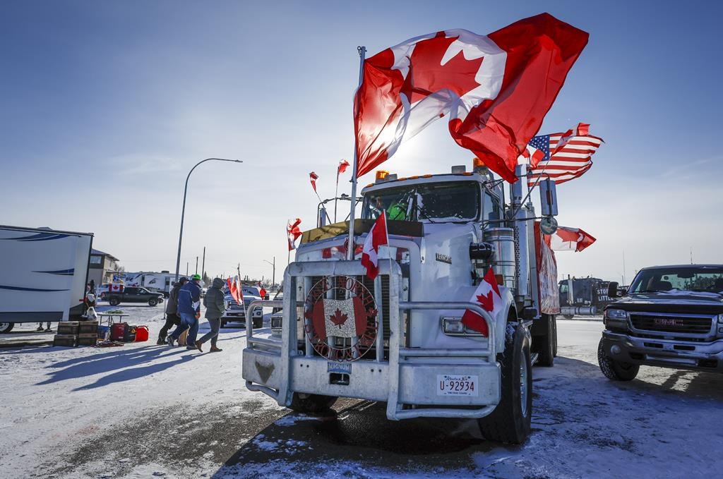 The last truck blocking the southbound lane moves after a breakthrough to resolve the impasse at a protest blockade at the United States border in Coutts, Alta., Wednesday, Feb. 2, 2022.