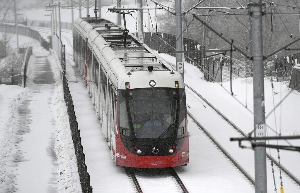 An Ottawa LRT train on the Confederation Line during a snowstorm in Ottawa, Thursday, Feb. 27, 2020.