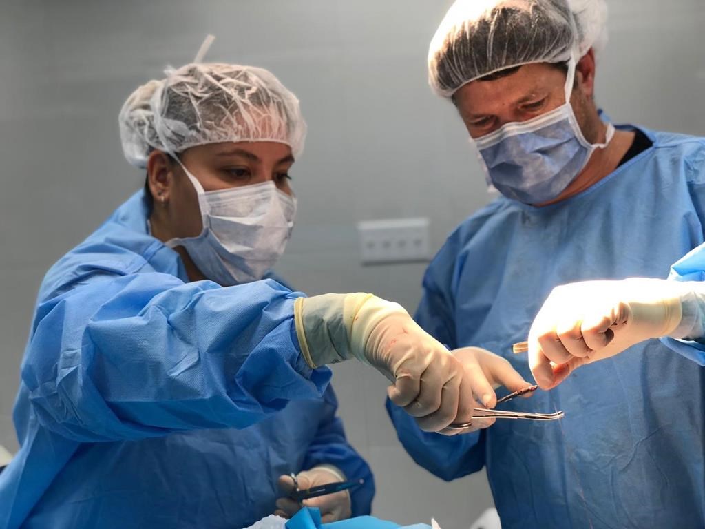 Physician assistant Joanna Chan, left, assists plastic surgeon Dr. Michel Gallant, right, with the placement of a skin graft to a child's head during an operation in Port-au-Prince, Haiti, in a 2018 handout photo. Chan was part of a medical team with the organization Team Broken Earth. THE CANADIAN PRESS/HO-Team Broken Earth, *MANDATORY CREDIT*.