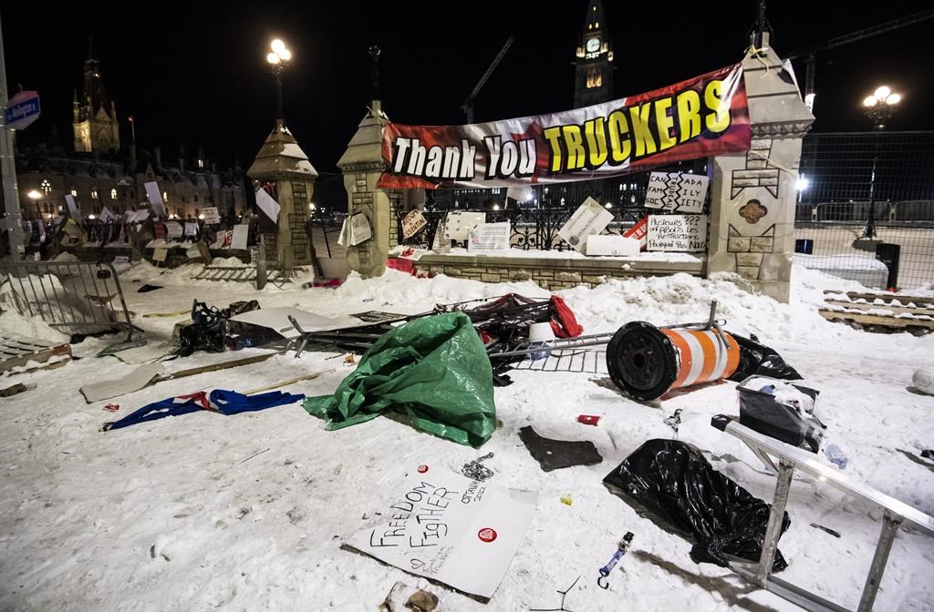 Debris lays on the ground in front of Parliament Hill's gates after police took action to clear the street of trucks and protesters to end a protest, which started in opposition to mandatory COVID-19 vaccine mandates and grew into a broader anti-government demonstration and occupation, on its 23rd day, in Ottawa, Saturday, Feb. 19, 2022. Being able to designate no-go zones, ensure tow trucks were available to remove vehicles and stop the flow of money and goods keeping the demonstrators fed and fuelled are all clear reasons the Emergencies Act was needed to end the Ottawa blockades, Public Safety Minister Marco Mendicino said.