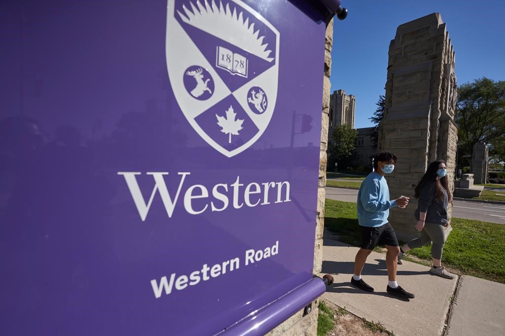 Students walk across campus at Western University in London, Ont., Saturday, Sept. 19, 2020.  Most Canadian universities, including Western are keeping in effect their COVID-19 vaccine and mask requirements for students attending in-person classes after several provinces announced recently plans to end many of the pandemic restrictions. THE CANADIAN PRESS/Geoff Robins.