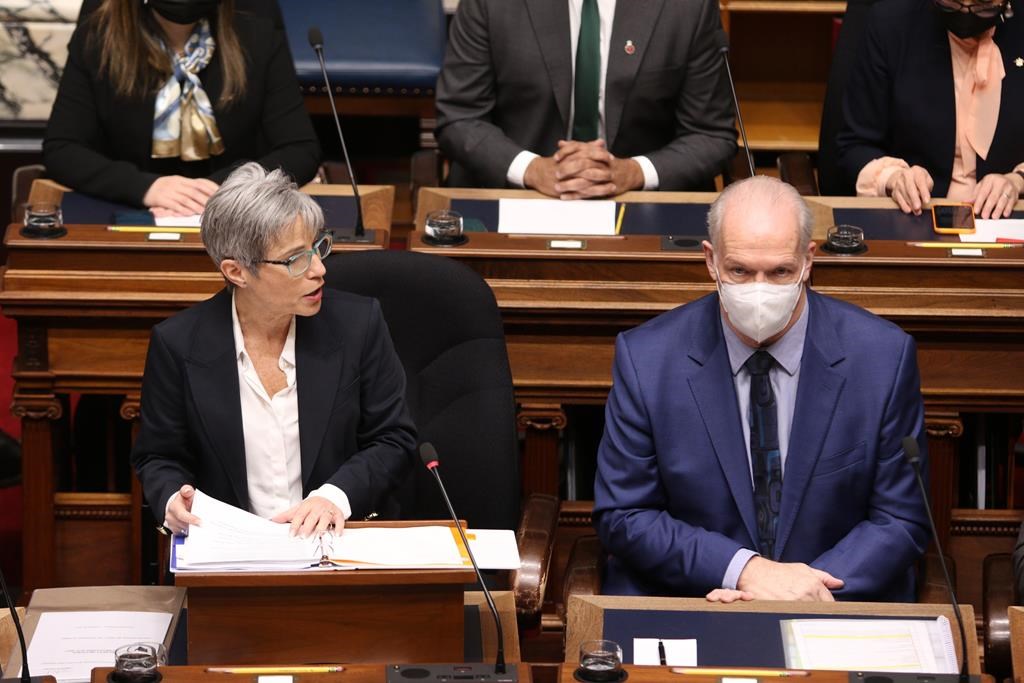 B.C. Premier John Horgan looks on as Finance Minister Selina Robinson delivers the budget speech in the legislature in Victoria on Tuesday, February 22, 2022. THE CANADIAN PRESS/Chad Hipolito.
