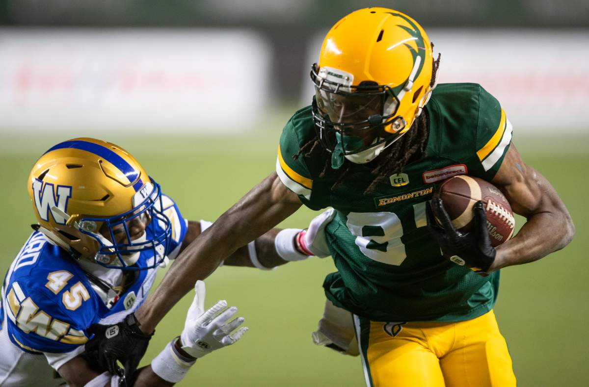 Winnipeg Blue Bombers' DeAundre Alford (45) tries to tackle Edmonton Elks' Derel Walker (87) during first half CFL action in Edmonton on Friday, October 15, 2021. 