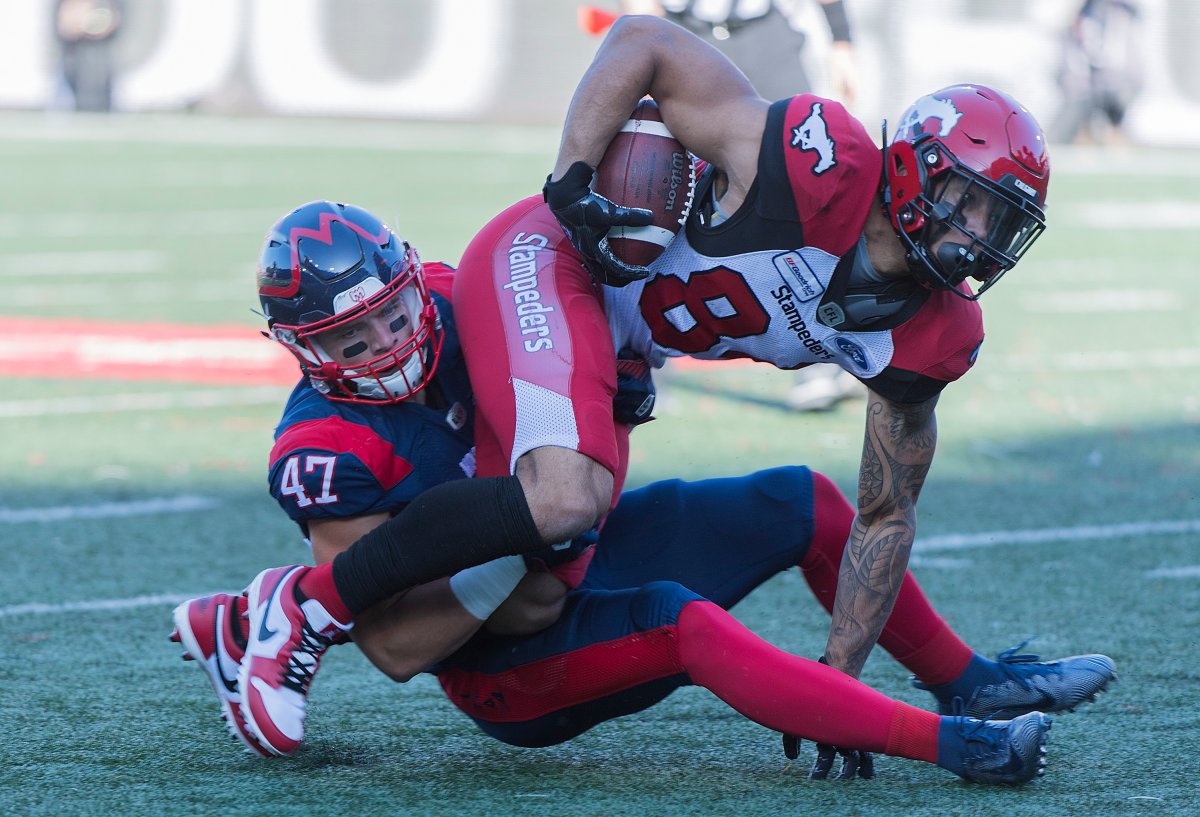 Montreal Alouettes' DJ Lalama (47) brings down Calgary Stampeders' Reggie Begelton during first half CFL football action in Montreal, Saturday, Oct. 5, 2019.