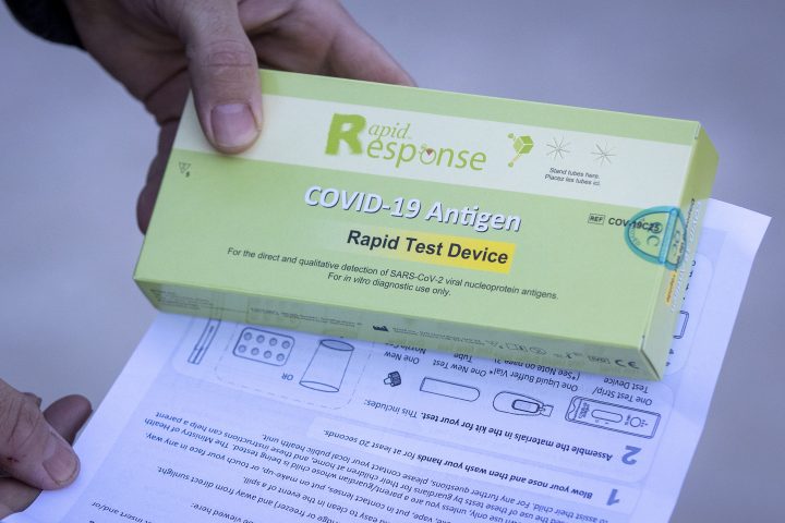 A person holds a free rapid antigen test that was handed out at Queen's University in Kingston, Ontario on Tuesday January 11, 2022. 