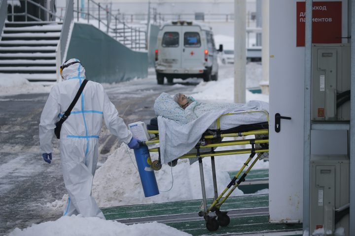 Medical workers carry a patient suspected of having coronavirus on a stretcher at a hospital in Kommunarka, outside Moscow, Russia, Saturday, Jan. 29, 2022. 