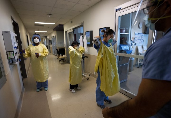 Health-care workers are seen in the intensive care unit at Humber River Hospital during the COVID-19 pandemic in Toronto on Tuesday, Jan. 25, 2022.