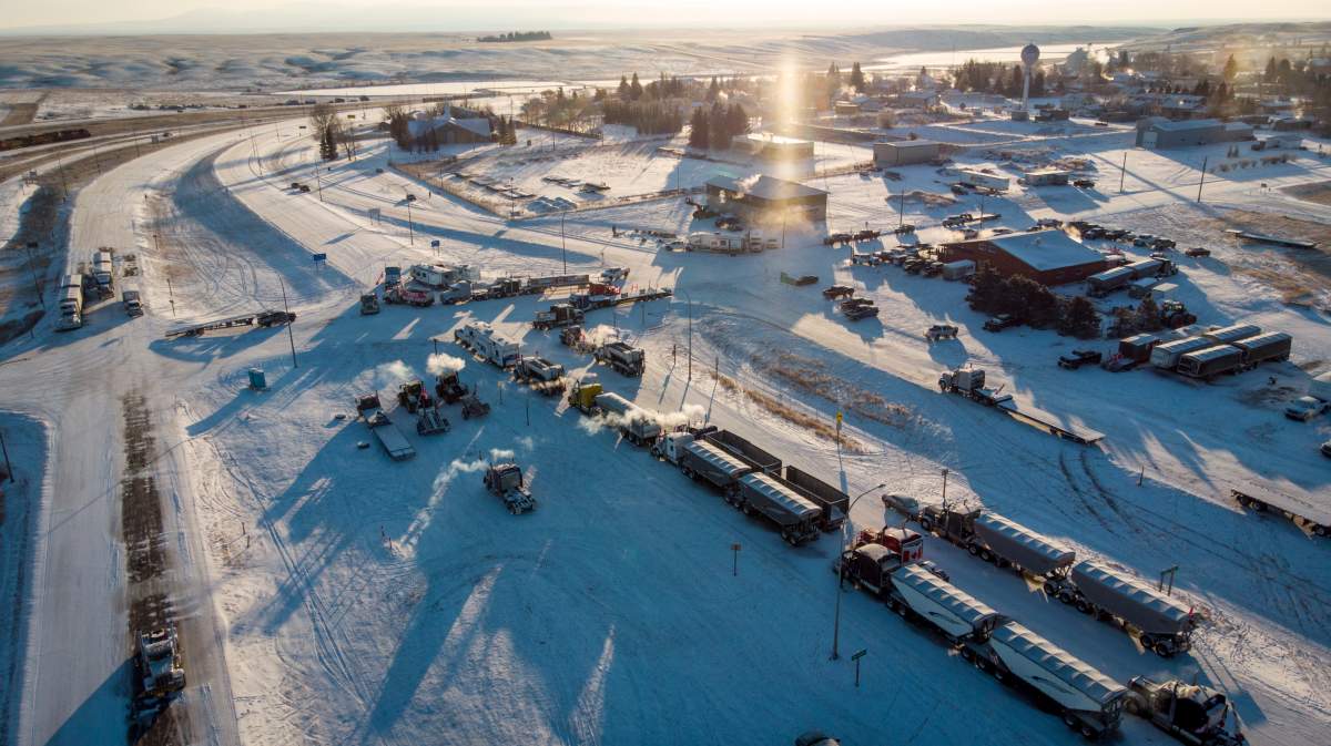A truck convoy of anti-COVID-19 vaccine mandate demonstrators continue to block the highway at the busy U.S. border crossing in Coutts, Alta., Wednesday, Feb. 2, 2022.