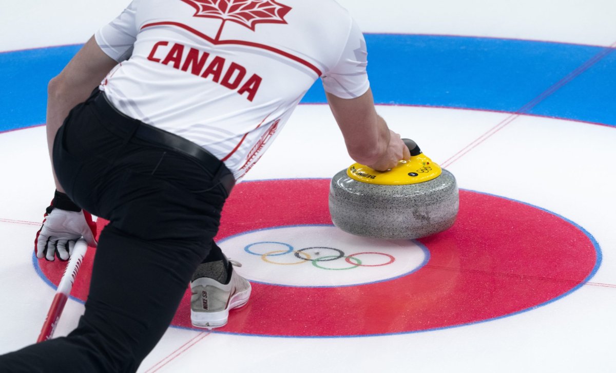 Canada's John Morris delivers a shot as they face Great Britain's Bruce Mouat and Jennifer Dodds in mixed doubles curling play at the 2022 Winter Olympics in Beijing on Thursday, February 3, 2022. THE CANADIAN PRESS/Paul Chiasson.