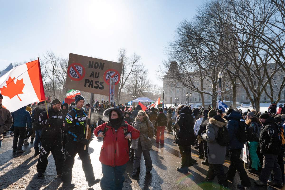 A few thousand people demonstrate against sanitary measures in front of the legislature in protest against COVID-19 restrictions, in Quebec City, Saturday, Feb. 5, 2022.