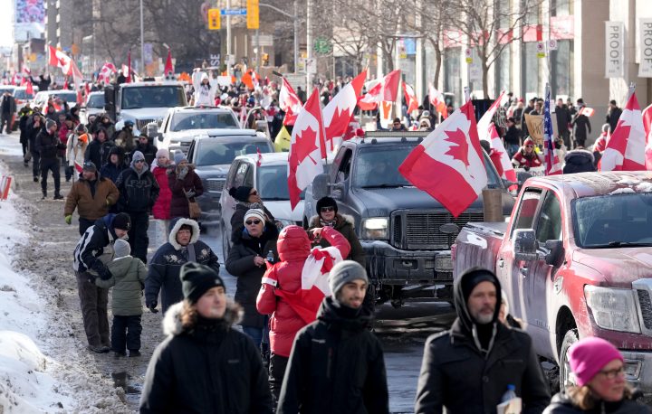 Trucks and supporters travel down Bloor Street during a demonstration in support of a trucker convoy in Ottawa protesting COVID-19 restrictions, in Toronto, Saturday, Feb. 5, 2022.