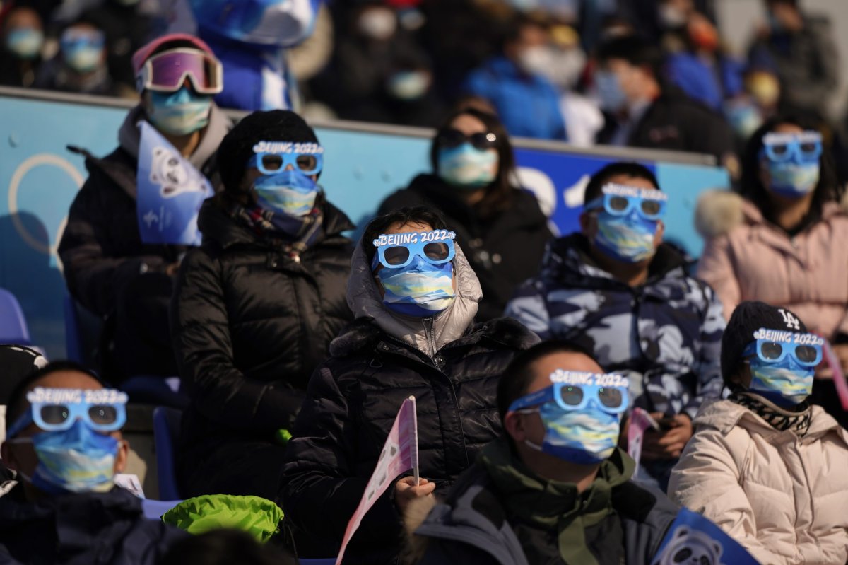 Spectators watch the men's snowboard big air finals of the 2022 Winter Olympics, Tuesday, Feb. 15, 2022, in Beijing. (AP Photo/Jae C. Hong).