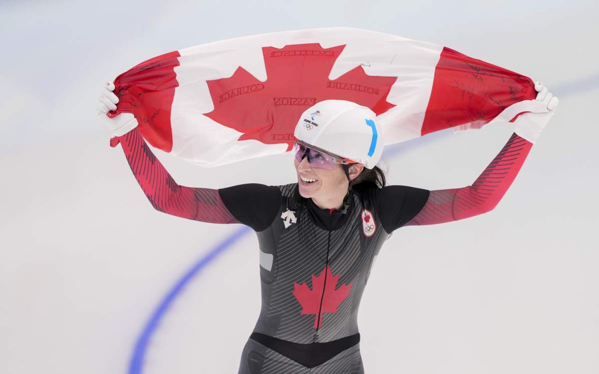 Canada's Ivanie Blondin celebrates her silver medal in the women's mass start speedskating final at the 2022 Winter Olympics in Beijing on Saturday, February 19, 2022. THE CANADIAN PRESS/Paul Chiasson.