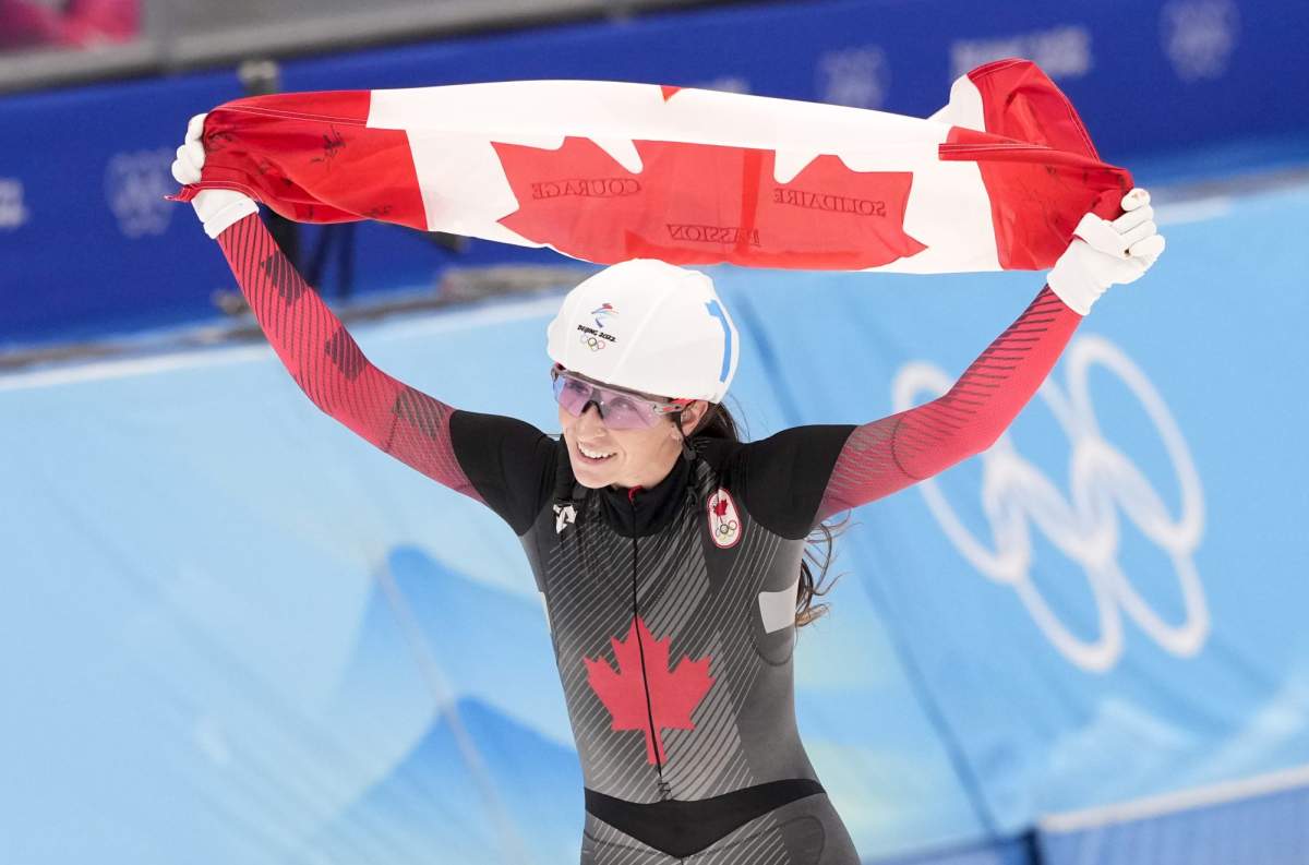 Canada’s Ivanie Blondin celebrates her silver medal in the women’s mass start speedskating final at the 2022 Winter Olympics in Beijing on Saturday, February 19, 2022. THE CANADIAN PRESS/Paul Chiasson