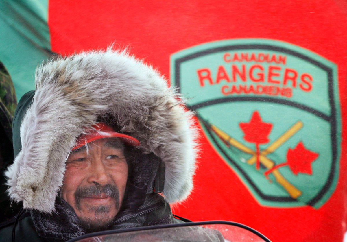Ranger Roger Hitkolok, from Kugluktuk, Nu. waits on his snowmobile as a Canadian Ranger flag flies behind him during a sovereignty patrol near Eureka, on Ellesmere Island, Nunavut. THE CANADIAN PRESS/Jeff McIntosh.
