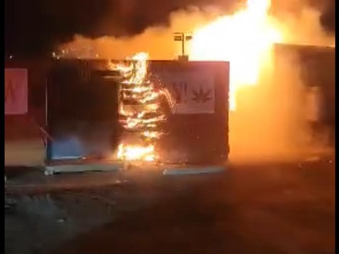 Flames and smoke rise from a fire at a cannabis dispensary fire in Oliver, B.C., early Tuesday. Police say arson is suspected and they are investigating.