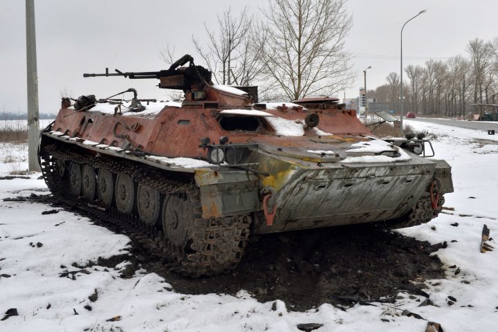 A destroyed Russian military vehicle is seen on the roadside on the outskirts of Kharkiv on Feb. 26, 2022, following the Russian invasion of Ukraine. (SERGEY BOBOK/AFP via Getty Images)