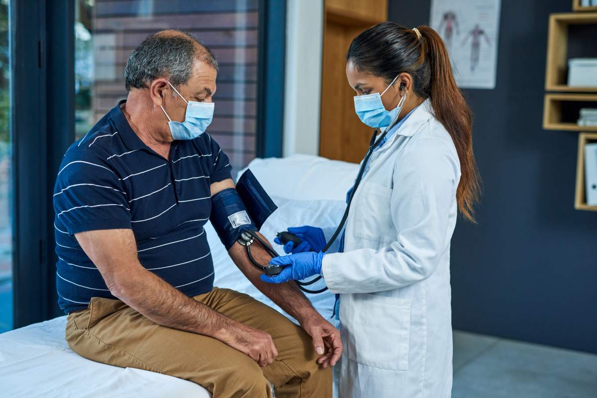 Shot of a doctor examining a senior patient with a blood pressure gauge