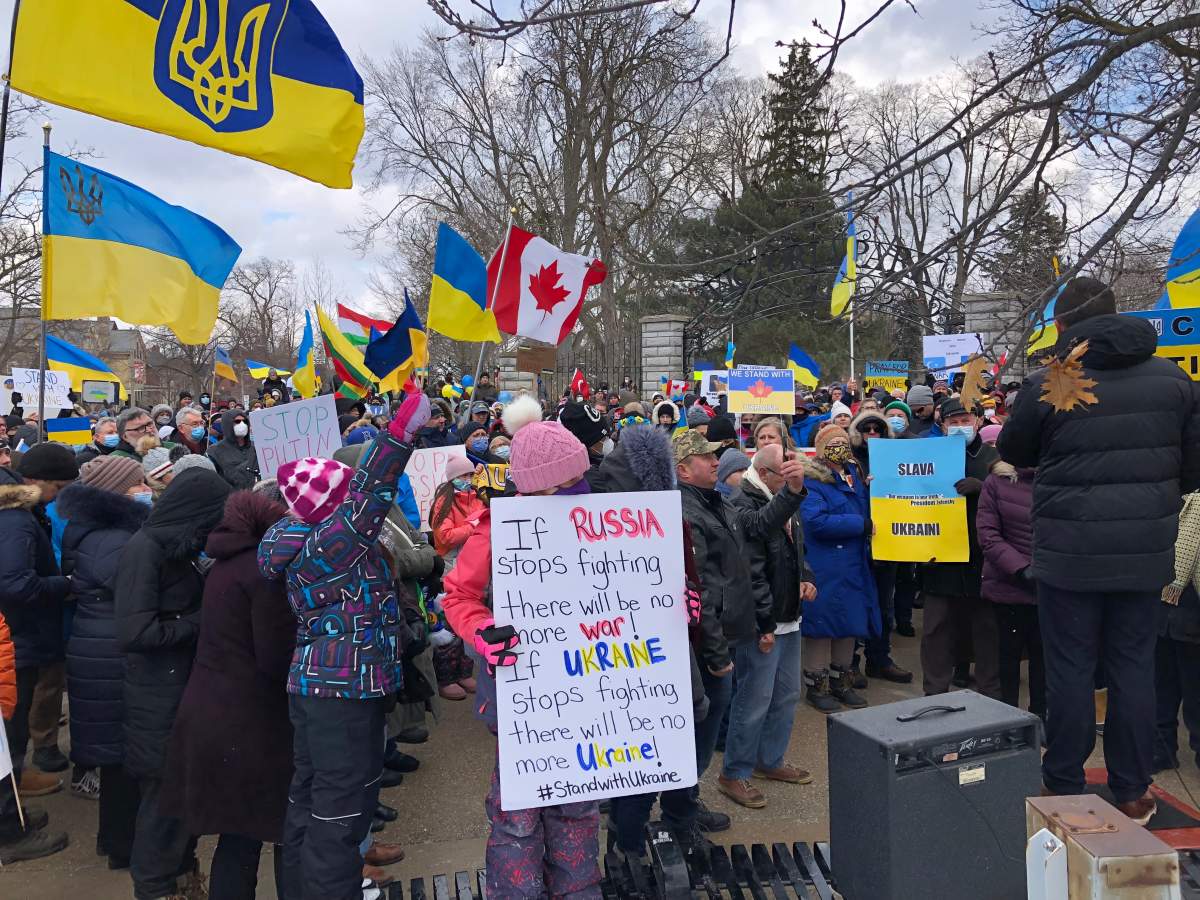 A young protestor holds a sign calling for peace in Ukraine during Sunday’s anti-war rally.