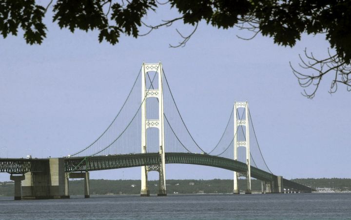 FILE - This July 19, 2002, file photo, shows the Mackinac Bridge that spans the Straits of Mackinac from Mackinaw City, Mich. Michigan Gov. Gretchen Whitmer, ordered Canadian energy company Enbridge last fall to shut down its Line 5 — a key piece of a crude delivery network from Alberta's oil fields to refineries in the U.S. Midwest and eastern Canada. A section roughly 4 miles (6.4 kilometers) long crosses the bottom of Michigan's Straits of Mackinac, which connects Lake Michigan and Lake Huron. AP Photo/Carlos Osorio, File).