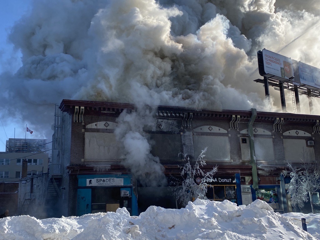 Smoke pours out of a building on Langside Street