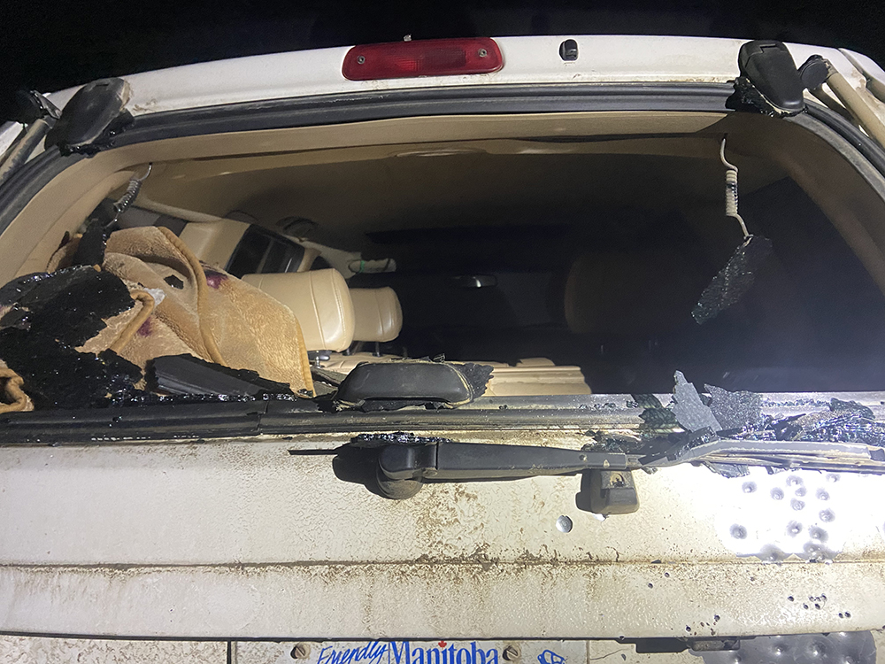 A vehicle with its window shot out.