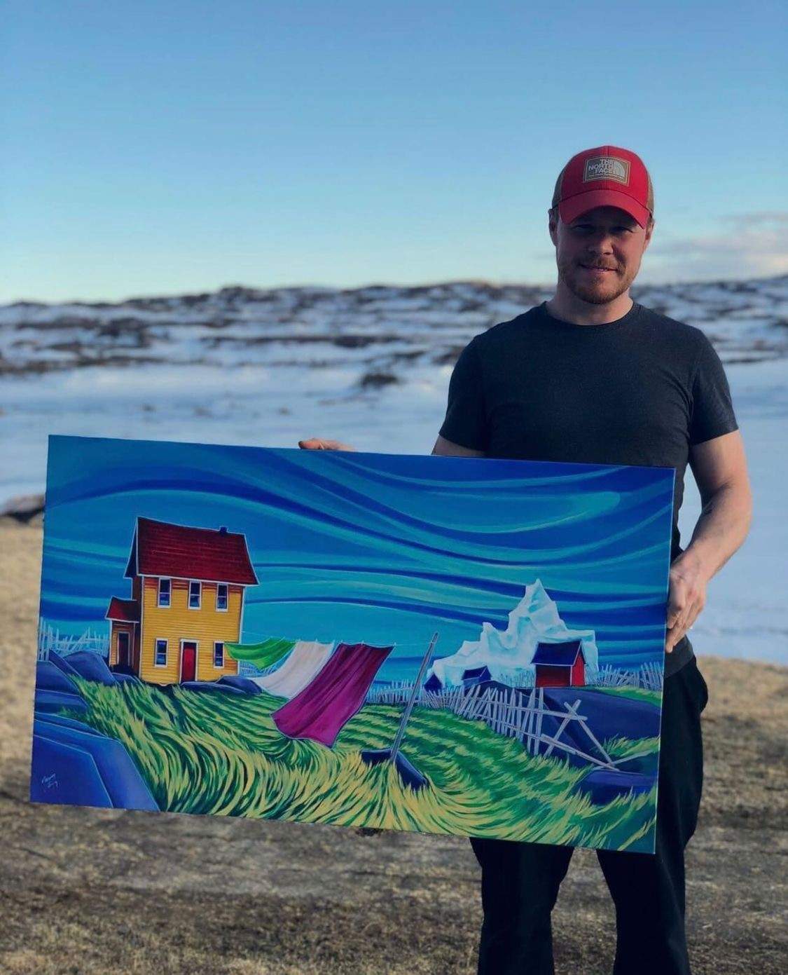 Artist Adam Young is seen holding his painting “Gusty,” in a photo taken last November.