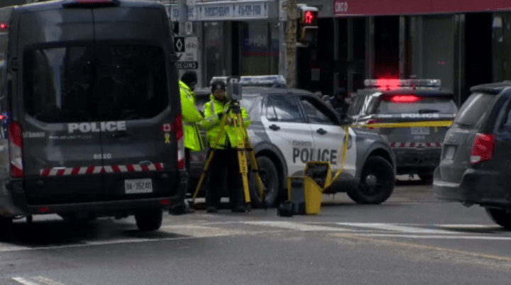 Police at the scene of a fatal collision at Bay and College streets in Toronto on Friday.