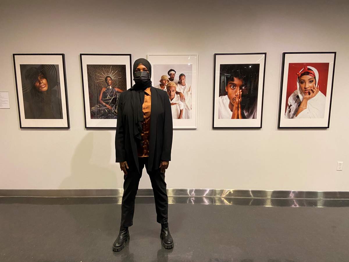 Photographer Faisa Omer is pictured with her photos for the 5 Artists 1 Love exhibit at the Art Gallery of Alberta