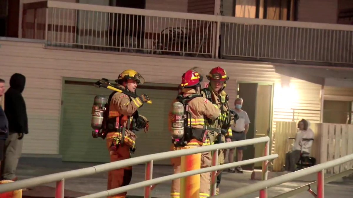 Calgary firefighters assess the damage at a southwest apartment.