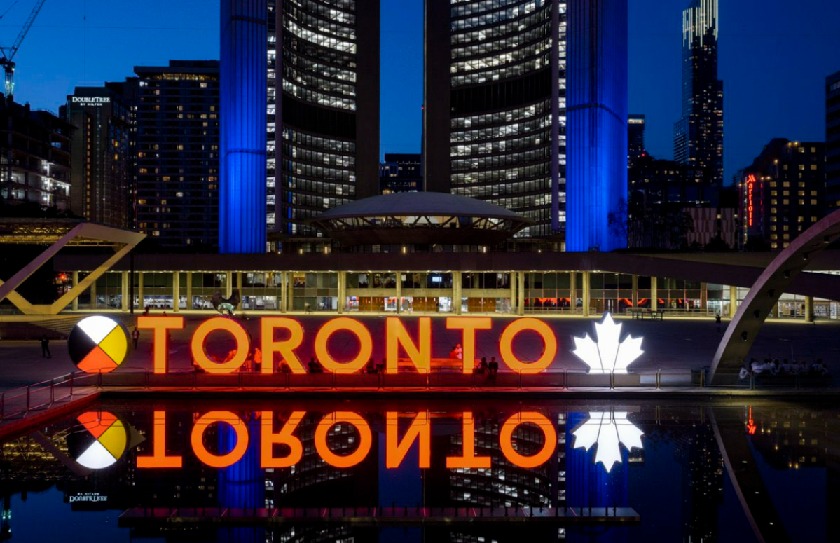 Toronto Mayor John Tory said the Toronto sign would be lit orange on Tuesday and Wednesday in memory of those found buried in unmarked graves in Saskatchewan.