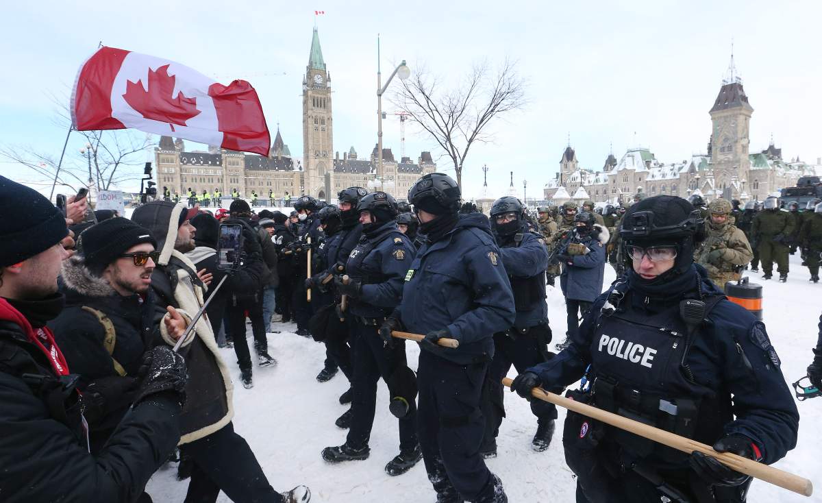 Police remove protesters from the ‘Freedom Convoy’ in Ottawa from Wellington Street in front of Parliament Hill on Feb. 19, 2022.