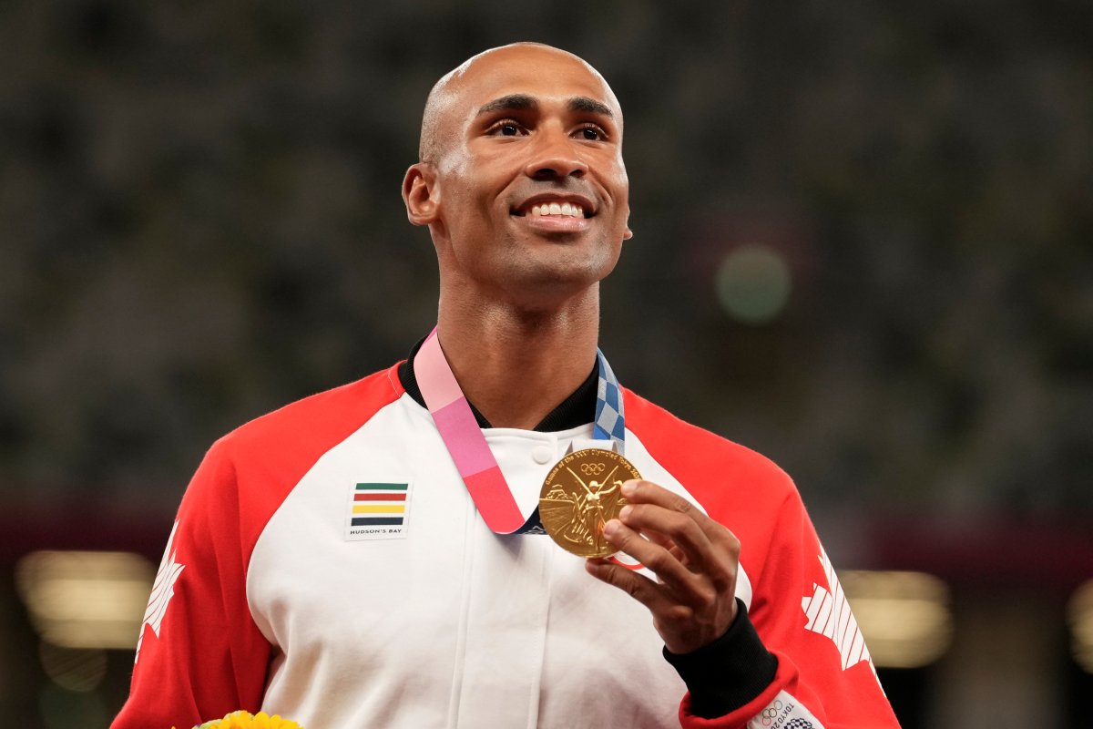 Gold medalist Damian Warner, of Canada, center, poses during the medal ceremony for the decathlon at the 2020 Summer Olympics, Friday, Aug. 6, 2021, in Tokyo.