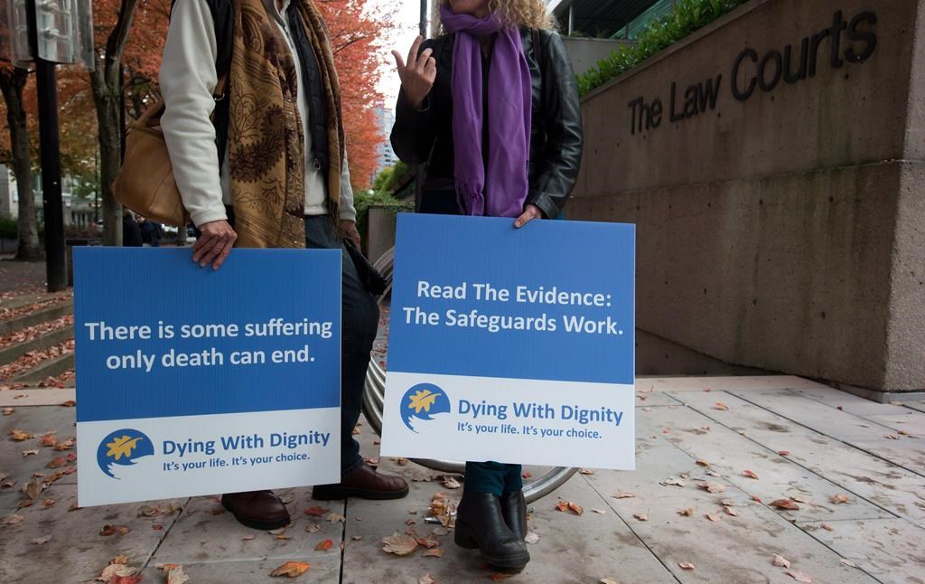 Assisted-suicide supporters wait outside the B.C. Court of Appeal before the court overturned a lower court ruling that said Canada's assisted-suicide ban violated the charter rights of gravely ill Canadians, in Vancouver, B.C., on Thursday October 10, 2013. THE CANADIAN PRESS/Darryl Dyck.