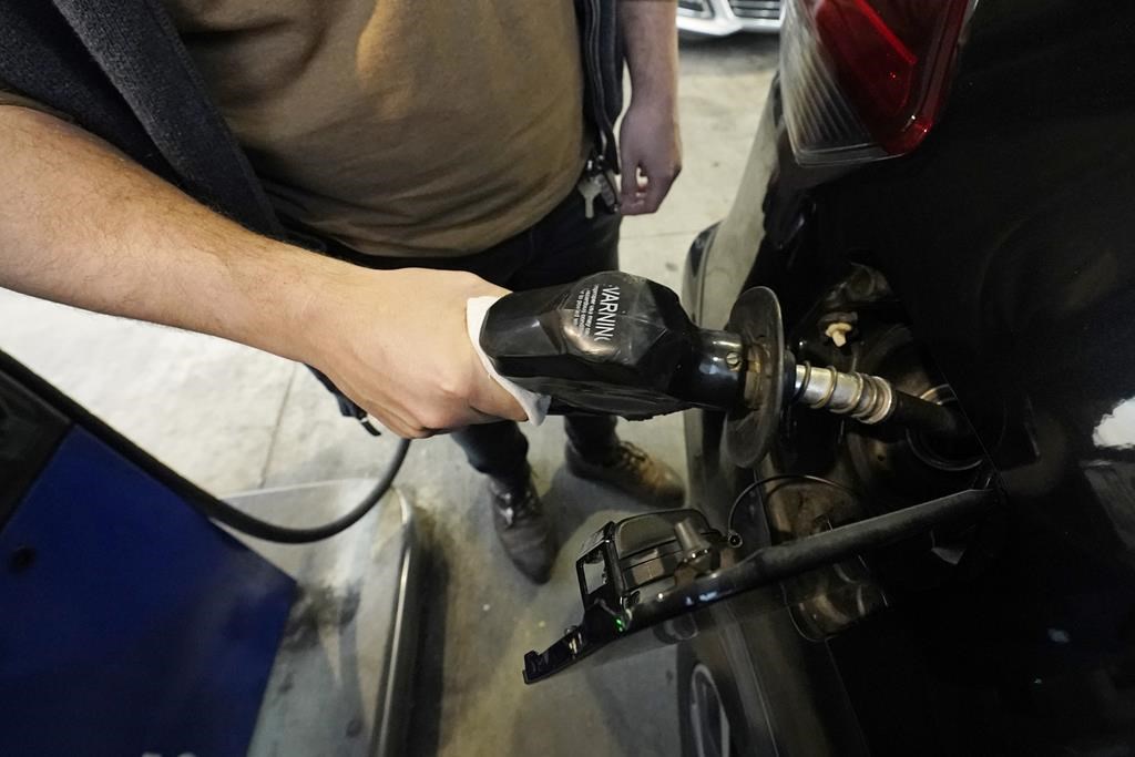 A customer pumps gasoline into his car at a Sam's Club fuel island in Gulfport, Miss., Feb. 19, 2022.
