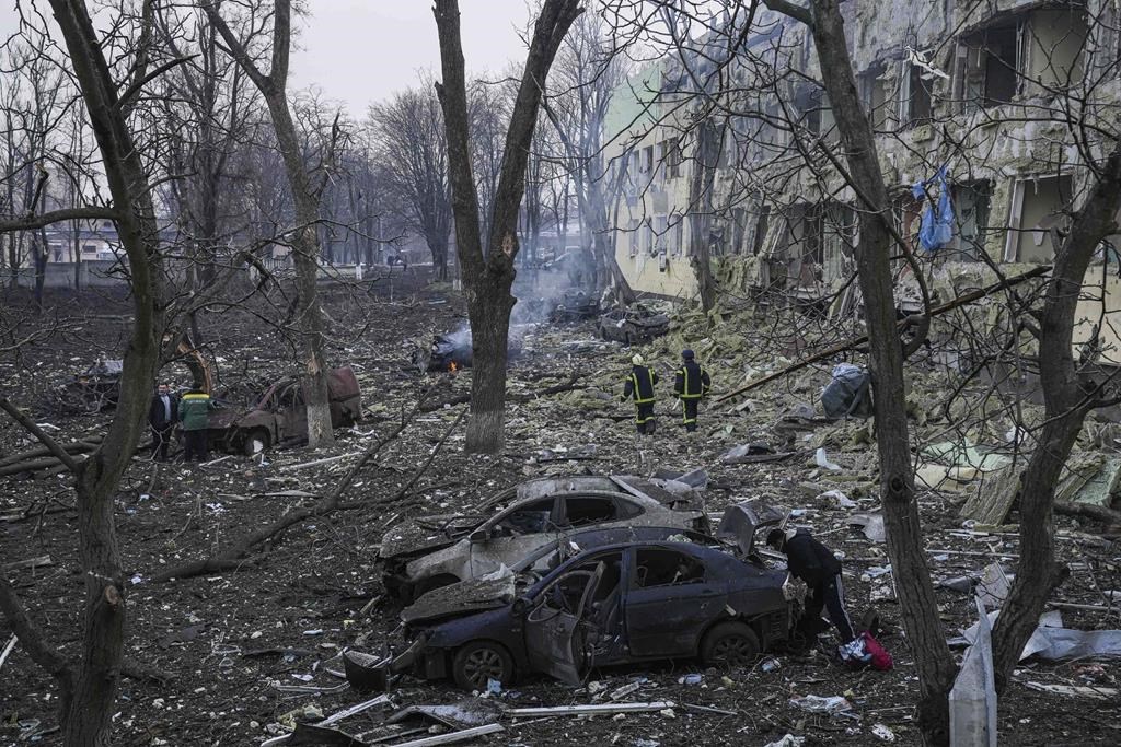 Ukrainian emergency employees work at the side of the damaged by shelling maternity hospital in Mariupol, Ukraine, Wednesday, March 9, 2022. A Russian attack has severely damaged a maternity hospital in the besieged port city of Mariupol, Ukrainian officials say. (AP Photo/Evgeniy Maloletka)