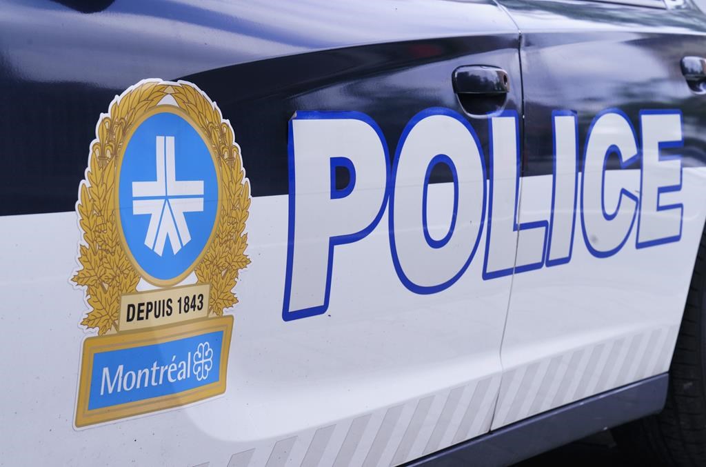 The Montreal Police logo is seen on a police car in Montreal on July 8, 2020. Montreal police homicide investigators say they've arrested a suspect in Nova Scotia in connection with an October 2021 homicide. 