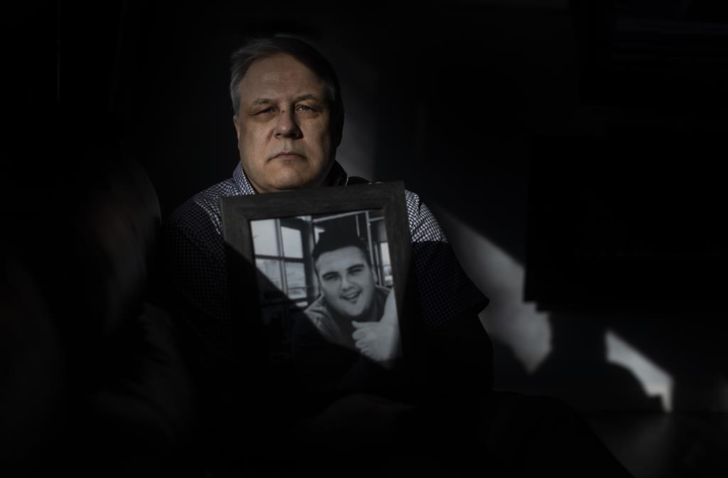 Ray Corbiere holds a picture of his son Joshua Corbiere in Edmonton on Wednesday, March 16, 2022. A father's hope turned to pain in less than 24 hours after his son entered a residential drug treatment facility and fatally overdosed.