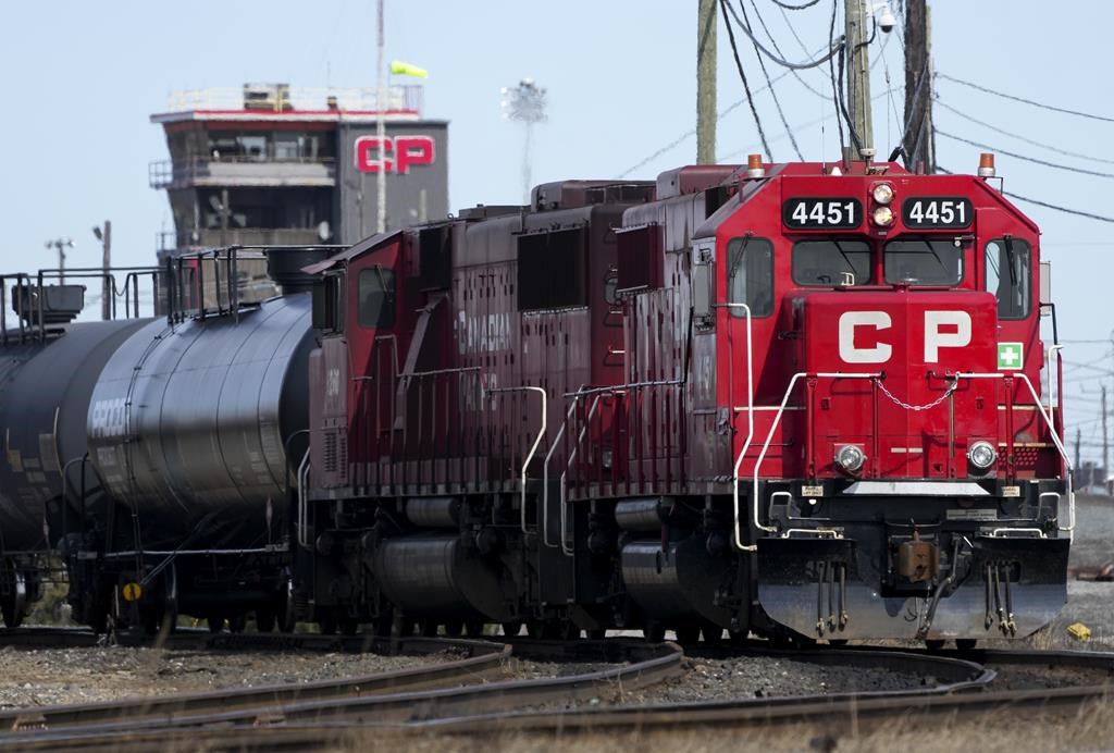 Canadian Pacific Railway trains sit idle on the train tracks.