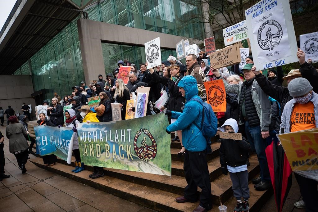 Members of the Nuchatlaht First Nation and supporters rally outside the B.C. Supreme Court before the start of an Indigenous land title case in Vancouver on Monday, March 21, 2022. The lawsuit brought by the First Nation against the provincial government seeks to reclaim part of its territory on Nootka Island. THE CANADIAN PRESS/Darryl Dyck.