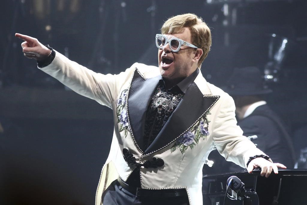 FILE - Elton John performs at Madison Square Garden during his Farewell Yellow Brick Road Tour in New York on Feb. 22, 2022. The singer has added 11 new dates on the North American leg of his farewell tour, including concerts in New Jersey, Massachusetts, California, Arizona, New Jersey and Washington. (Photo by Greg Allen/Invision/AP, File).