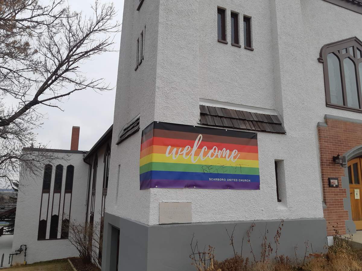 Damage and graffiti is seen on a banner welcoming LGBTQ2S+ people on Calgary’s Scarboro United Church, in an undated photo. Calgary police are investigating the incident as a possible hate motivated crime.