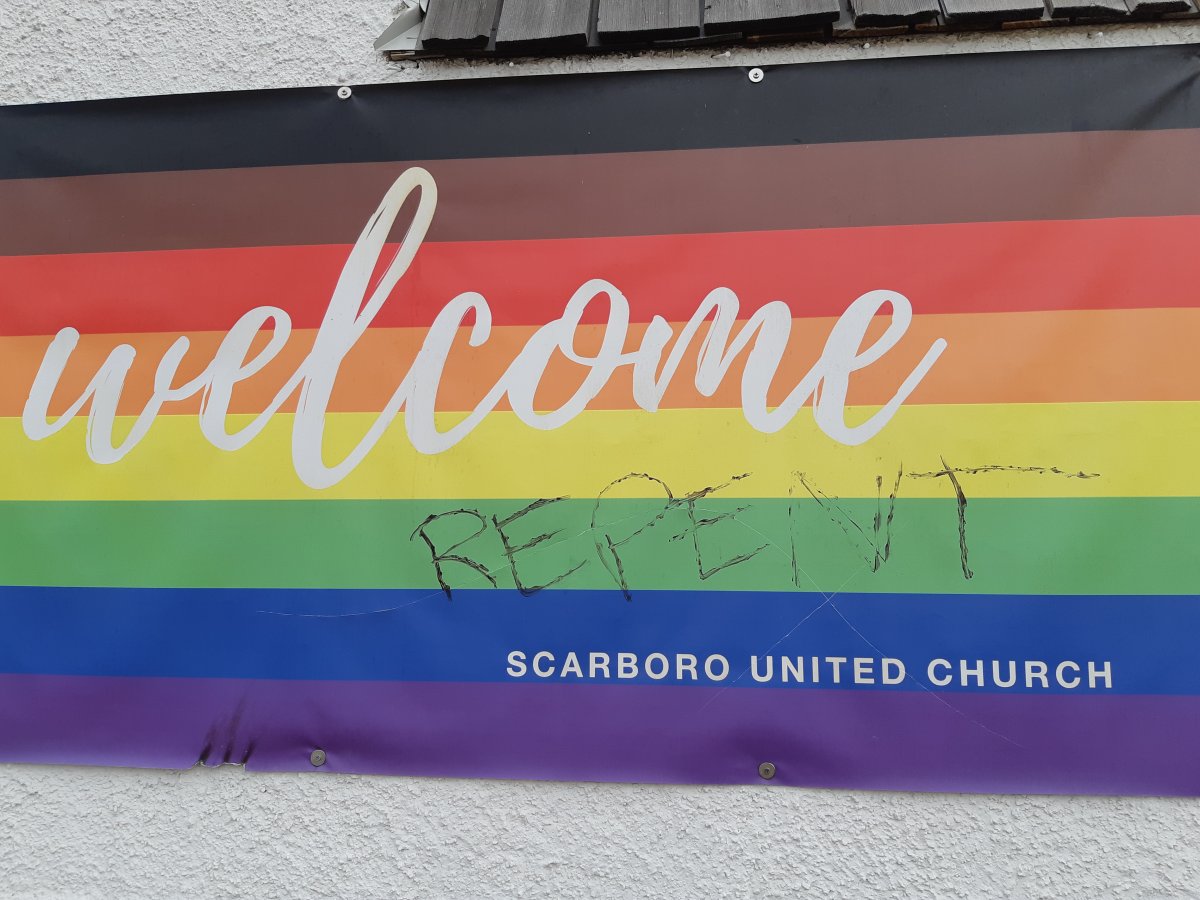 Damage and graffiti is seen on a banner welcoming LGBTQ2S+ on Calgary's Scarboro United Church, in an undated photo.