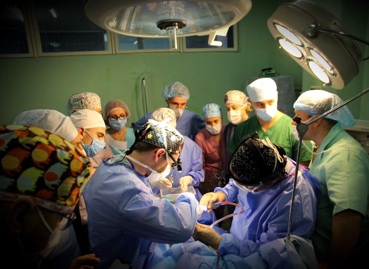 Ukrainians and Canadians assist each other during a surgery while on a medical mission in Ukraine.