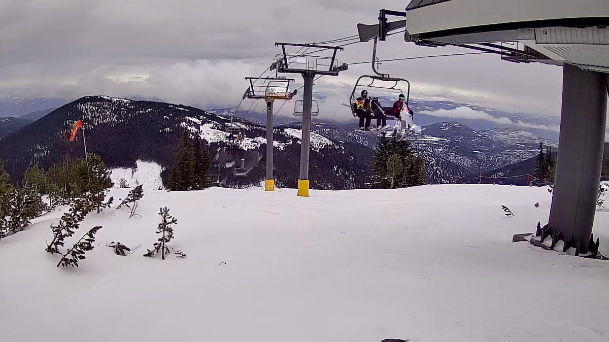 Skiers riding a lift at Apex Mountain Resort near Penticton, B.C., on Friday, March 18, 2022.