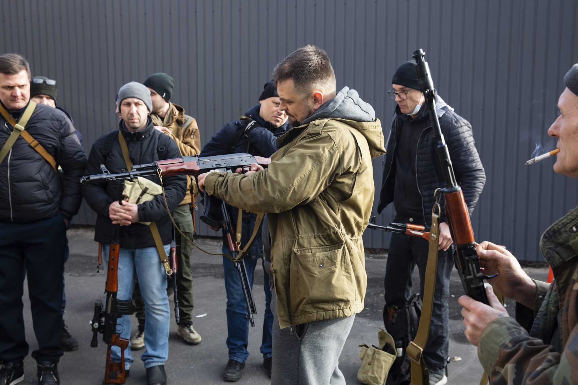 Civilian Members of a territorial defence unit fit their weapons to repel the Russian attacking forces in Kyiv, Ukraine, Saturday, Feb. 26, 2022. Russian troops stormed toward Ukraine’s capital Saturday, and street fighting broke out as city officials urged residents to take shelter. (AP Photo/Mikhail Palinchak)