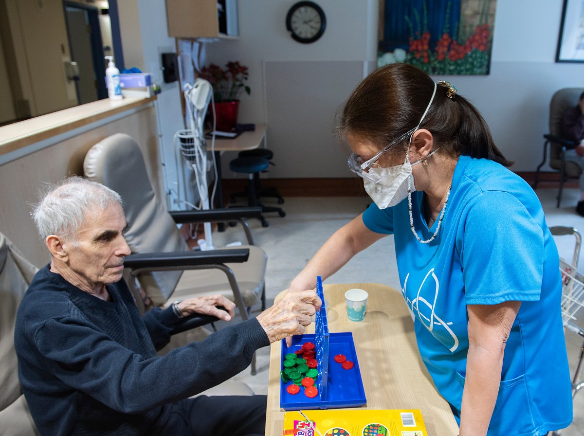 A man plays a game with a health-care worker