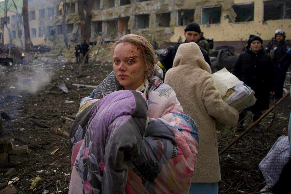 FILE - Mariana Vishegirskaya stands outside a maternity hospital that was damaged by shelling in Mariupol, Ukraine, March 9, 2022. Vishegirskaya survived the shelling and later gave birth to a girl in another hospital in Mariupol.