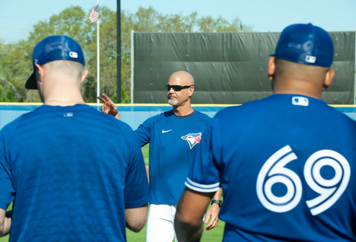 Toronto Blue Jays’ pitching coach Pete Walker, centre, talks with pitchers during a spring training workout, Thursday, March 17, 2022, in Dunedin, Fla. 
