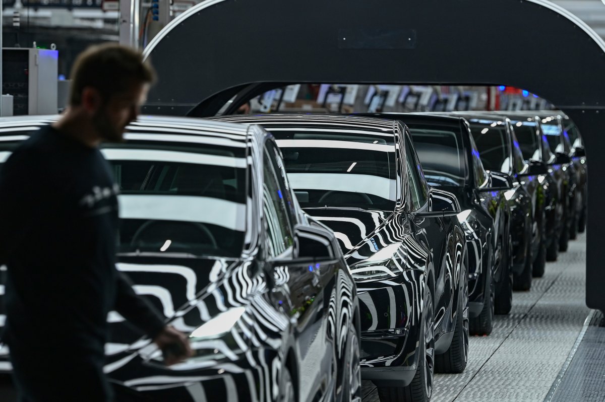 Model Y electric vehicles stand on a conveyor belt at the opening of the Tesla factory in Berlin Brandenburg in Gruenheide, Germany, Tuesday, March 22, 2022.